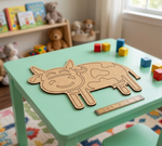 Children's room with a green table featuring a MDF DIY cow puzzle and colorful blocks.