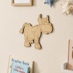 MDF DIY cow wall decoration on a beige wall with books below