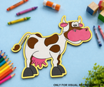 Colorful MDF DIY cow cutout with crayons and markers on a blue background
