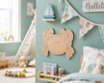 Children's room with a MDF DIY crab wall decoration, toys, and a bed.