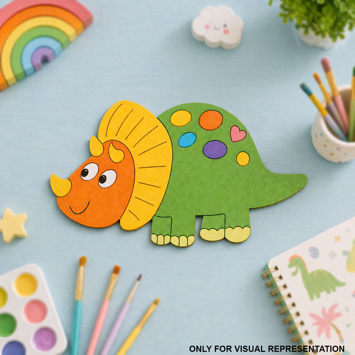 Colorful MDF DIY dinosaur craft on a light blue background with art supplies.
