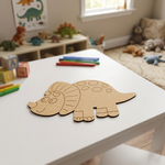  MDF DIY dinosaur puzzle on a child's table with toys and a window in the background