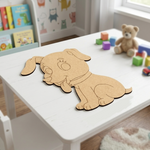 MDF DIY  dog cutout on a white table with toys and books in the background