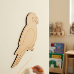 MDF DIY parrot cutout on cream wall.