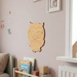 Unpainted owl MDF wall hanging displayed on a nursery wall above a children's bookshelf.