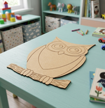 MDF DIY  owl cutout on wooden table.