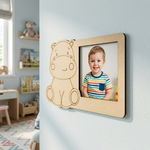 MDF DIY  bear-shaped frame with a child's photo on a wall in a room with toys and books.