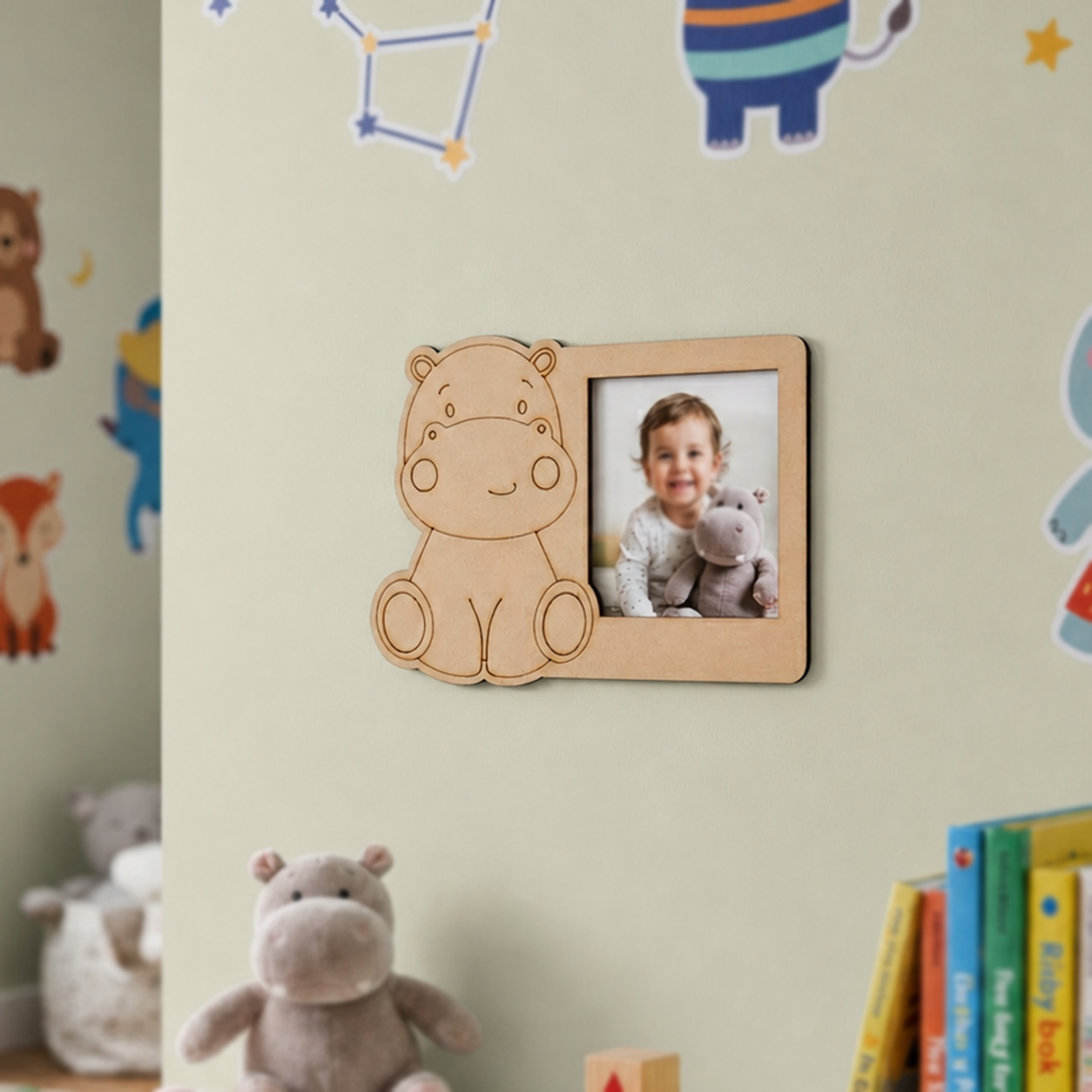 MDF DIY  hippo-shaped photo frame with a child's picture on a wall with children's decor.
