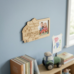 MDF DIY  photo frame with farm design on a wall with books and toys below.