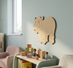 MDF DIY  hippo wall decoration in a child's room with toys and books on a table.