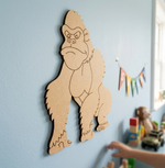 MDF DIY gorilla wall decoration on a light blue wall with toys in the background.