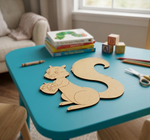 Children's play area with   MDF DIY squirrel cutout, books, and toys on a blue table.