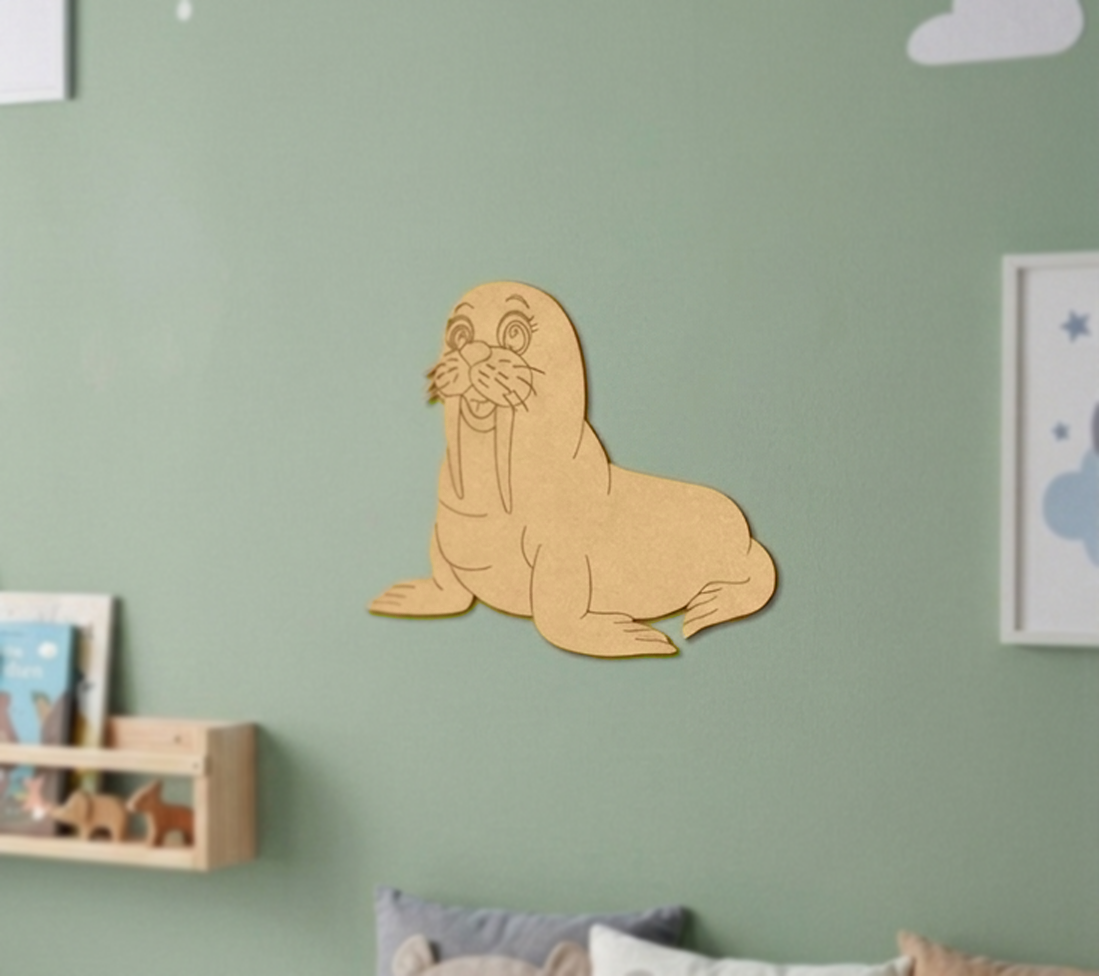 MDF DIY walrus wall decoration on a green wall with children's books and toys below.