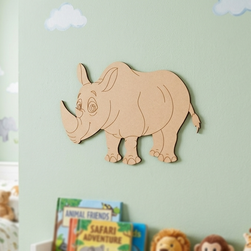 MDF DIY  rhino wall decoration on a light green wall with children's books below.