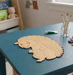 MDF DIY  hedgehog puzzle on a blue table with children's items in the background