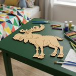 MDF DIY  moose cutout on a green table with art supplies in a room.