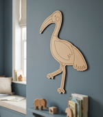 MDF DIY  bird wall decoration on a blue wall with children's items below.