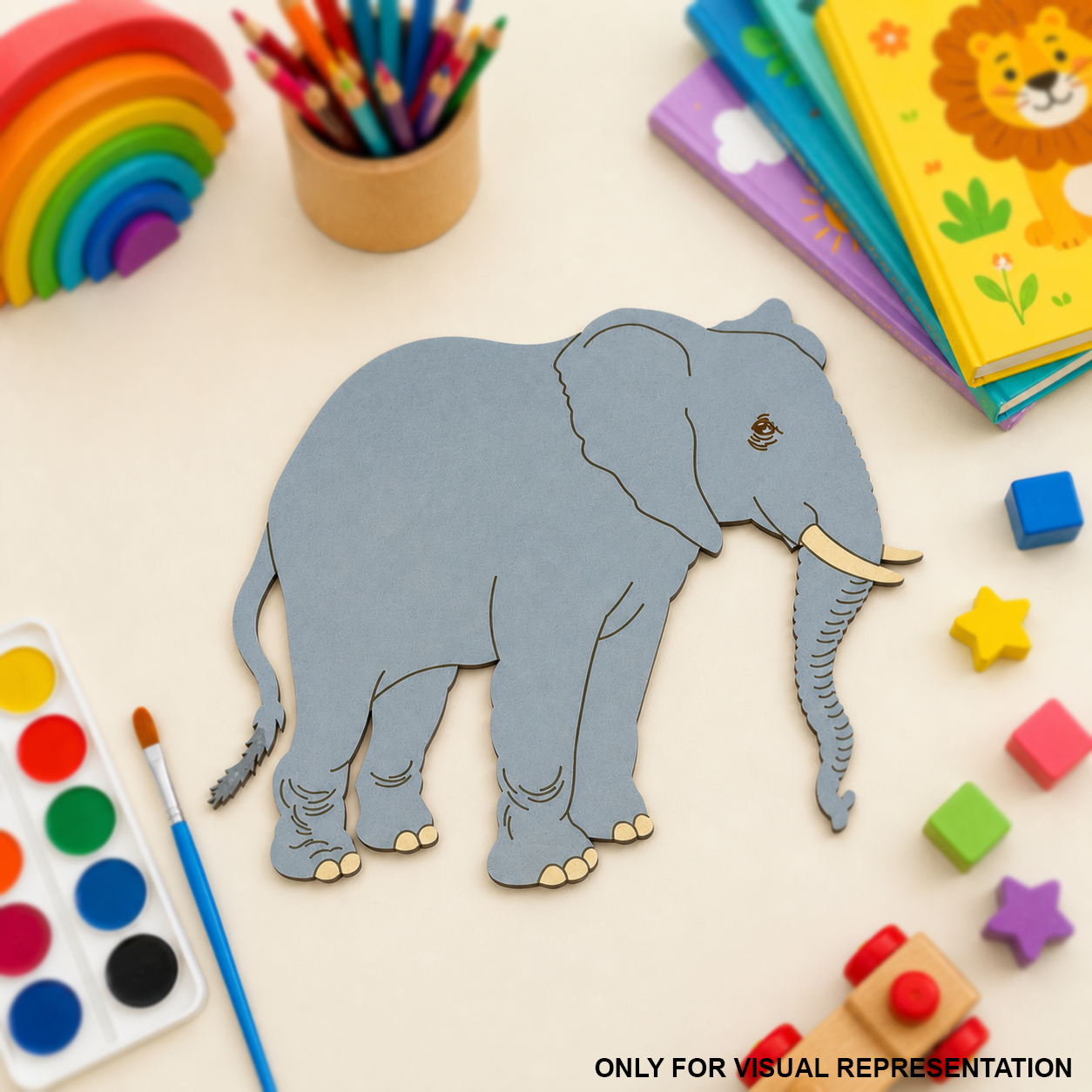 MDF DIY elephant cutout surrounded by colorful stationery items on a light surface.