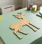 MDF DIY  deer cutout on a green table with colorful toys in the background