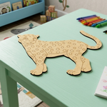 MDF DIY  leopard puzzle on a green table with colorful crayons and books in the background
