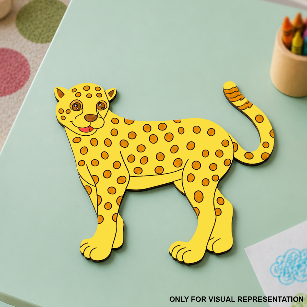 Colorful MDF DIY  leopard craft on a light green surface with crayons in the background
