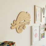 MDF DIY  chameleon wall decor on a light-colored wall with framed pictures.
