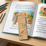 Open book with MDF DIY bookmark on a wooden surface with toy.
