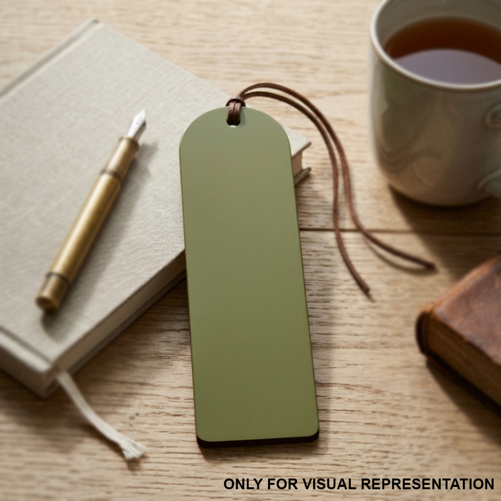 MDF DIY Green bookmark with string, notebook, pen, and cup of tea on a wooden surface.