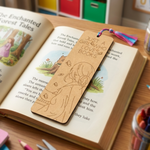 MDF DIY  bookmark with a design on an open book with stationery items in the background.
