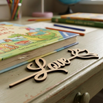  MDF DIY  bookmark 'love' sign on a desk with books and pencils in the background