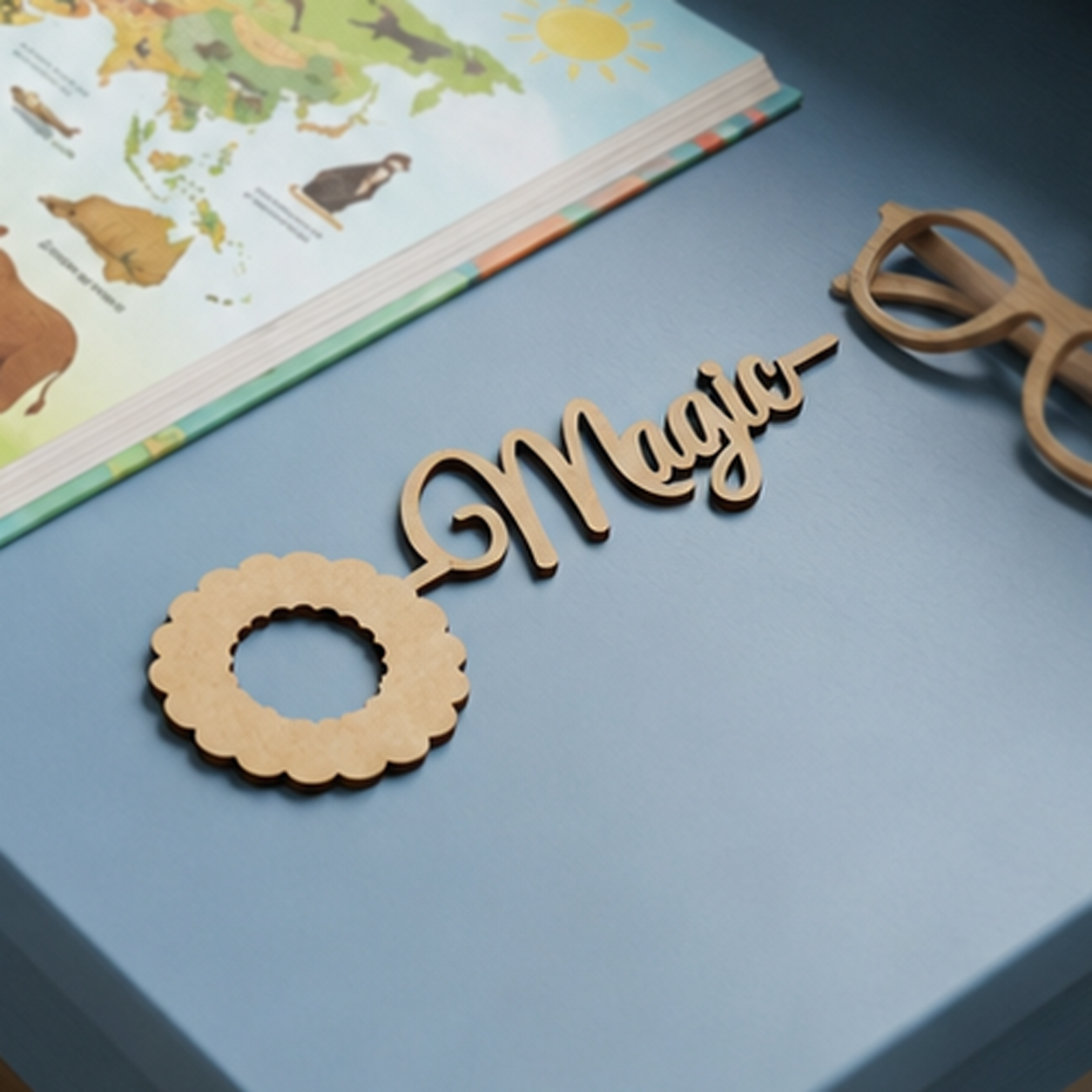 MDF DIY  Bookmark letters spelling 'Magic' on a blue surface with a children's book in the background.