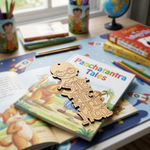 Children's book titled 'Panchatantra Tales' with MDF DIY  bookmark  piece on a desk with books and stationery.