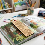 Children's book with a MDF DIY  bookmark featuring sun designs on a table with crayons and pencils.