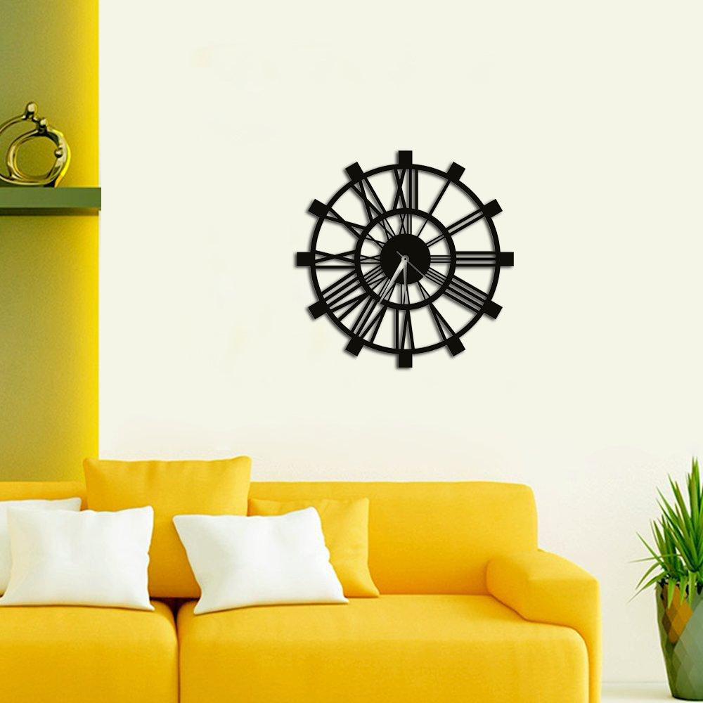 Elegant black mdf Roman numeral wall clock mounted on a light-colored wall, complementing a modern yellow sofa.