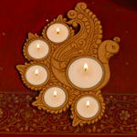 Decorative candle holder with five candles on a red fabric background