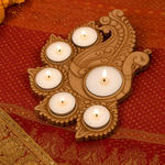 Decorative mdf candle holder with lit candles on a red fabric background