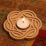 mdf candle holder with a lit candle on a patterned fabric background