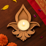 Decorative candle holder with a lit candle on a wooden surface with marigold flowers and petals.