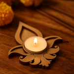Decorative mdf candle holder with a lit candle on a wooden surface
