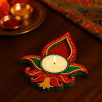 Decorative candle holder with a lit candle on a wooden surface