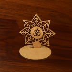 Decorative wooden Om tabletop piece with intricate lotus and leaf cutwork, placed on a wooden background, perfect for spiritual gifting