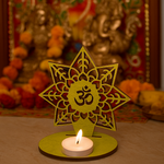 Decorative  mdf candle holder with Om symbol on a blurred festive background