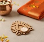Decorative mdf candle holder with a lit candle on a light surface with flowers and fabric.