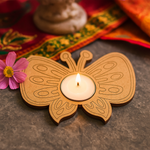 Butterfly-shaped mdf candle holder with a lit candle on a decorative background