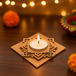 Decorative mdf candle holder with a lit candle on a wooden surface, blurred lights and flowers in the background