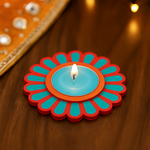 Decorative candle holder with a colorful floral design on a wooden surface