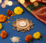 Decorative mdf candle holder with a lit candle surrounded by marigold flowers on a blue background.
