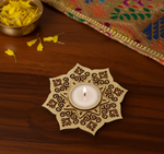 Decorative MDF candle holder with a lit candle on a wooden surface