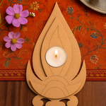 MDF Tealight candle holder with a lit candle on an orange fabric background with flowers.