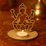 MDF Laxmi ji deity figure with a lit candle on an ornate fabric background